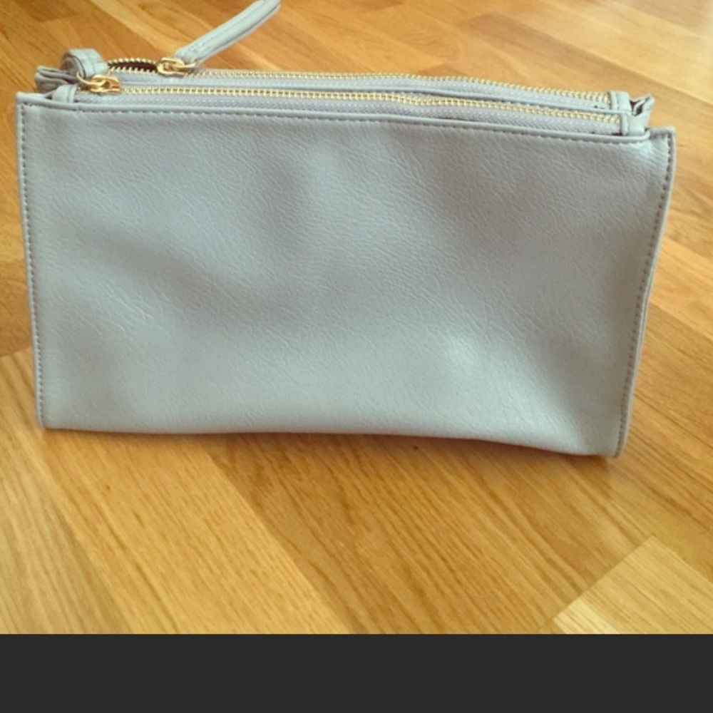 Gray clutch with gold zippers